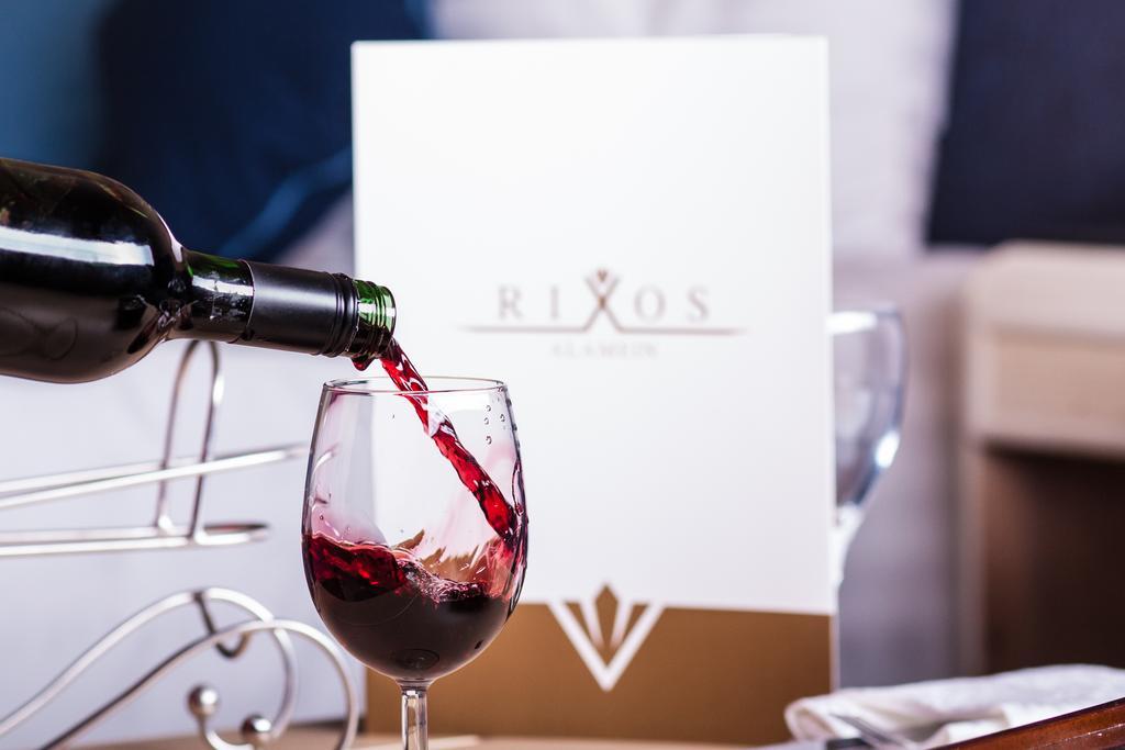 Rixos Alamein - Full Board Plus Ελ Αλαμέιν Εξωτερικό φωτογραφία Wine being poured into a wine glass